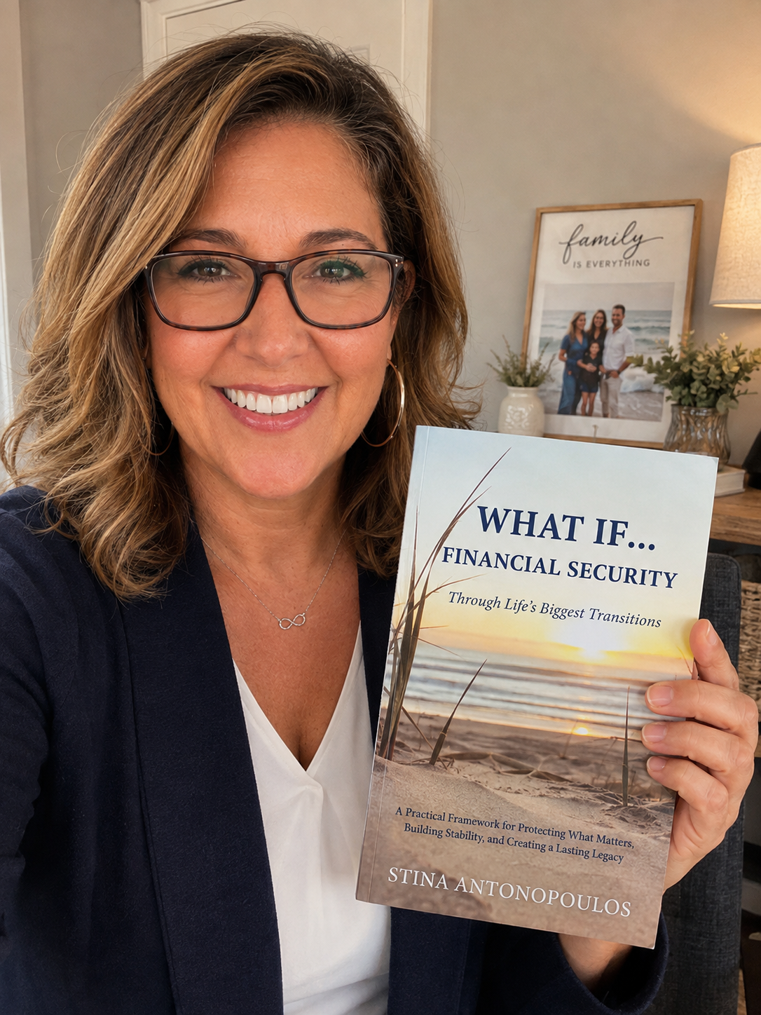 Stina Antonopoulos holding a copy of What If... Financial Security Through Life's Biggest Transitions
